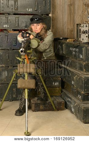 Portrait of armed combat soldier woman in ammunition
