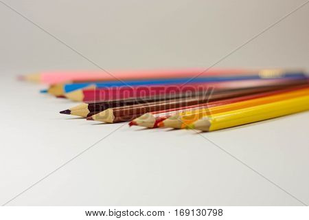 Colored pencils on white background close up isolated