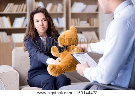 Woman with bear toy during psychologist visit