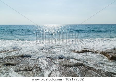Seascape water flows over the rocky shore