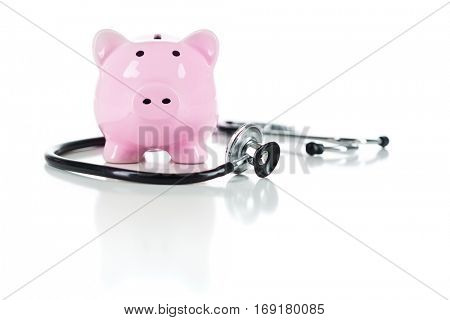 Piggy Bank and Stethoscope Isolated on a White Background.