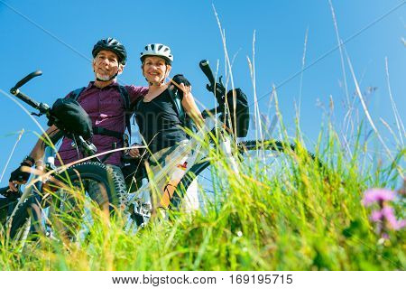 Cycling senior couple enjoying summer at the vilsalpsee in austria