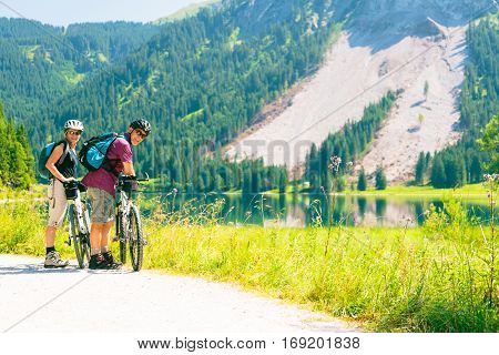Cycling senior couple enjoying summer at the vilsalpsee in austria