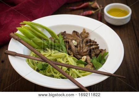 Plate Of Spaghetti Dough With Spinach And Oyster Mushrooms. Italian Cuisine, Italian Recipes. Wooden