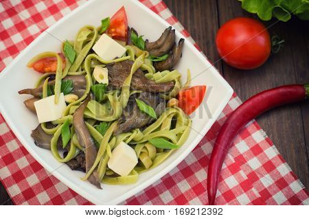 Plate Of Spaghetti Dough With Spinach And Oyster Mushrooms. Italian Cuisine, Italian Recipes. Wooden
