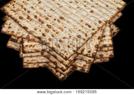 Traditional Jewish matzah on a black background. Close-up
