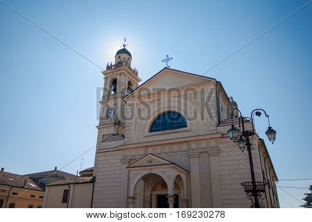 The church of Brescello with the sun filtering through the bell tower.