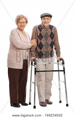 Full length portrait of a mature woman and a mature man with a walker isolated on white background