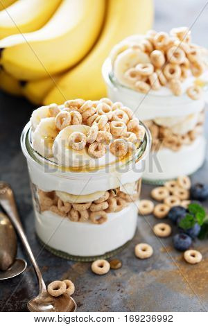 Yogurt parfait with cereal, banana and maple syrup