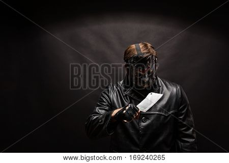 Bloody murderer in hockey mask with meat cleaver