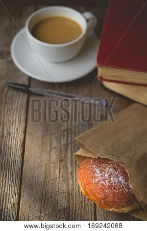 Relax time from book with Hot Coffee and Donut on wood Background used for food ad or website promote