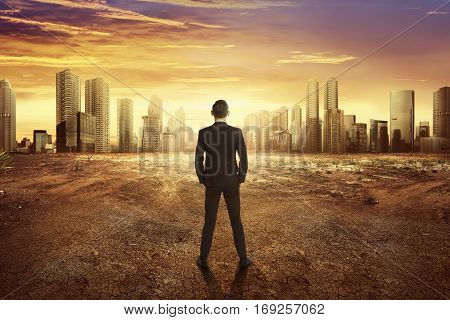 Back View Asian Businessman Looking Dry Land Effect Of The Climate Change