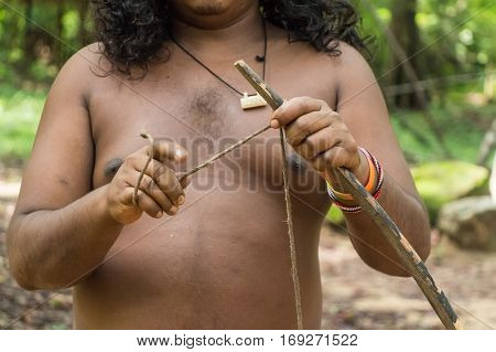 Vedda man holds bow and arrows. Veddas are an indigenous people of Sri Lanka living in tribes in the jungle