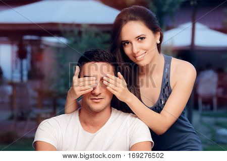 Woman Covering Man's Eyes Taking him by Surprise on a Blind Date