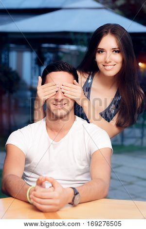 Woman Covering Man's Eyes Taking him by Surprise on a Blind Date