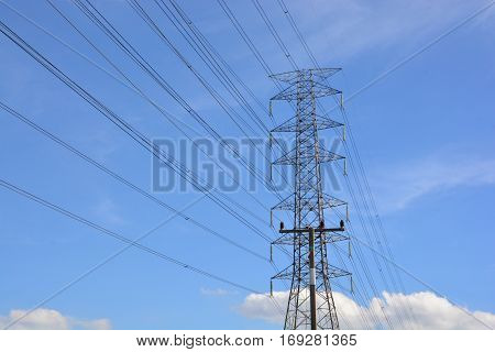 electricity transmission pylon against blue sky .