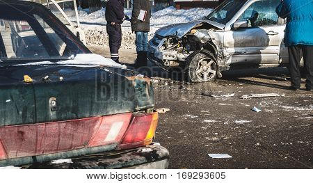 Auto accident involving three cars on a city street. Car crash