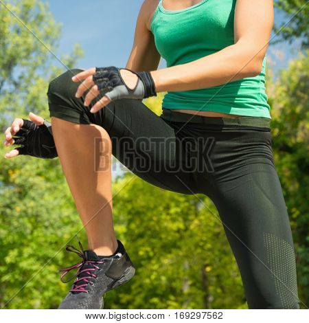 Young woman doing TaeBo outdoors, toned image