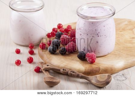 Smoothies with frozen berries red currants black currants and raspberries in two banks