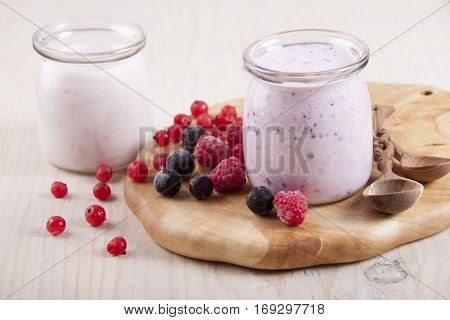 Smoothies with frozen berries red currants black currants and raspberries in two banks