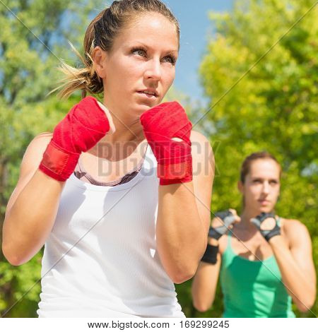Young women in guard stance on TaeBo training selective focus