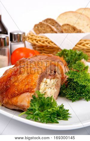 Stuffed turkey thigh with rice and egg on a white plate