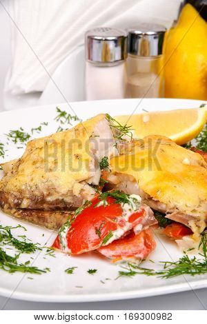 Fish Mate's with vegetables on the white plate with greens