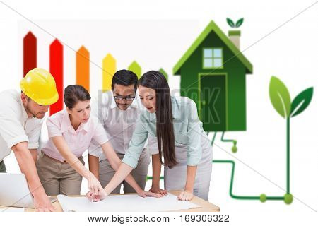 Architecture team working together at desk against clean energy house