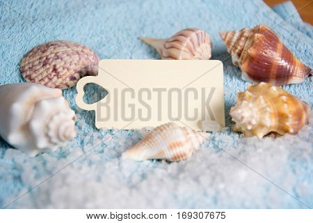 Shell with candle light and empty tag for wellness and relaxing concepts or massage advertising