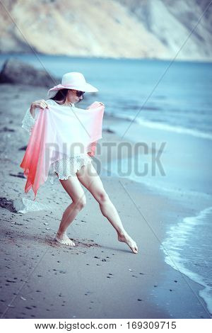 Happy woman enjoying beach relaxing joyful in summer by tropical blue water.