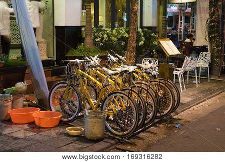 Hanoi, Vietnam - Nov 2, 2014: Row of bikes for rent on Ma May street at night, old quarter of Hanoi