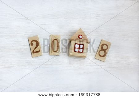 flat layout digits and house on a light wooden surface / personal property by 2018