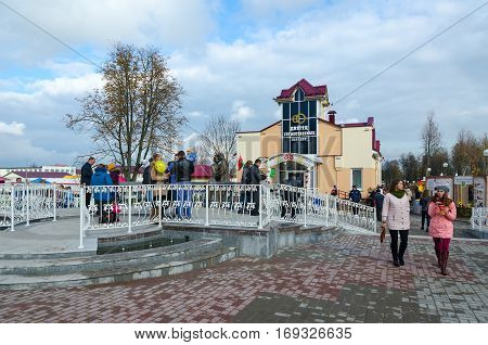 SENNO BELARUS - OCTOBER 8 2016: Unidentified people walk on town square near new building of Civil Registry Office during festival-fair Dozhinki 2016 in Senno Vitebsk region Belarus