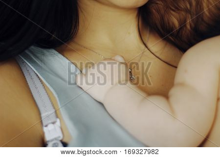 little baby asleep in the arms of his mother. small child's hand
