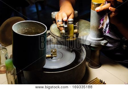 This is diamond cutting procss.It's changing a diamond from a rough stone into a faceted gem.