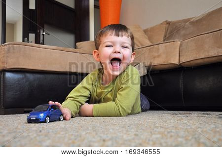 Happy kid play with his car toy