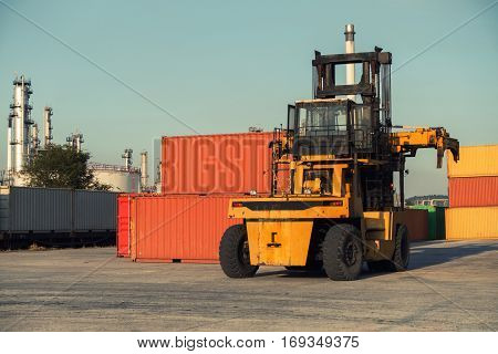 Forklift unloading and container stack in yard cargo shipping.