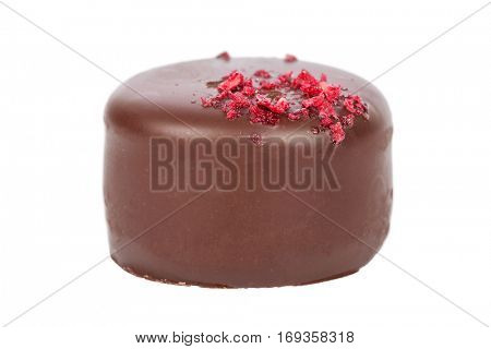 Gourmet bonbon, aka bon-bon or truffle made of dark chocolate. Closeup macro detail isolated on white background