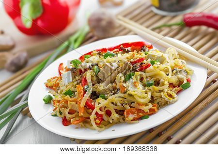 Asian meal made of rice noodles tofu vegetables and shiitake mushrooms. Traditional Oriental cuisine meal.