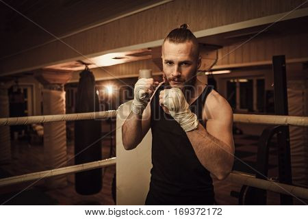 Fighter shadowboxing on training ring