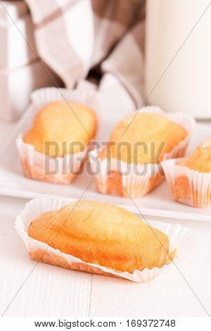 Breakfast with mini plumcake on white dish.