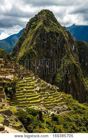 View of the Lost Incan City of Machu Picchu near Cusco, Peru. Machu Picchu is a Peruvian Historical Sanctuary. People can be seen on foreground.