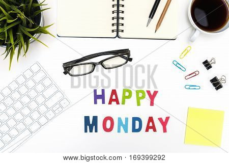 Office desk table with supply pen pencil notebook computer eye glasses sticky note cup of coffee and happy monday word on white background