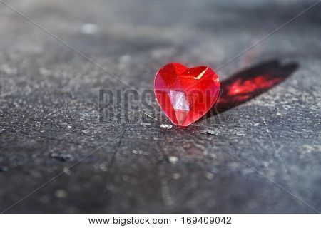 Red love heart with reflection on a gray stone surface valentine's or mother's day concept with copy space selected focus narrow depth of field