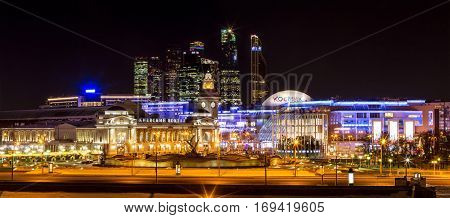 Moscow Russia - January 20 2017: Night winter panorama of the Moskva River embankment: Kiyevskaya railway station Moscow-City shopping center 