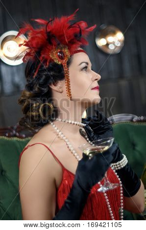 Middle aged beautiful women in Greate Gatsby style with glass of wine