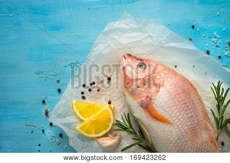 Fresh raw fish tilapia. Nile tiapia Oreochromis niloticus. Top view. Food cooking background.