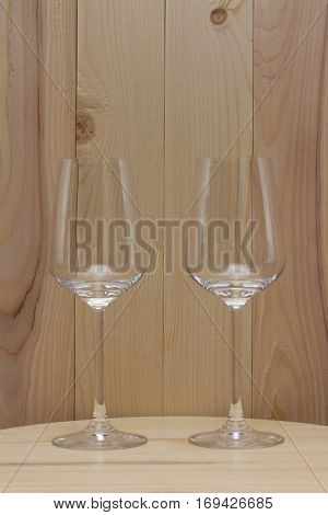 two transparent glass standing stand with a wooden background