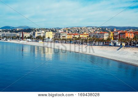 Beautiful Nice promenade, France. View of the sea, beach and Promenade des Anglais Embankment. French Riviera - turquoise sea and perfect recreation.
