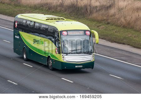 LONDON UK - FEBRUARY 6 2017: Greenline bus in motion on the British motorway M1